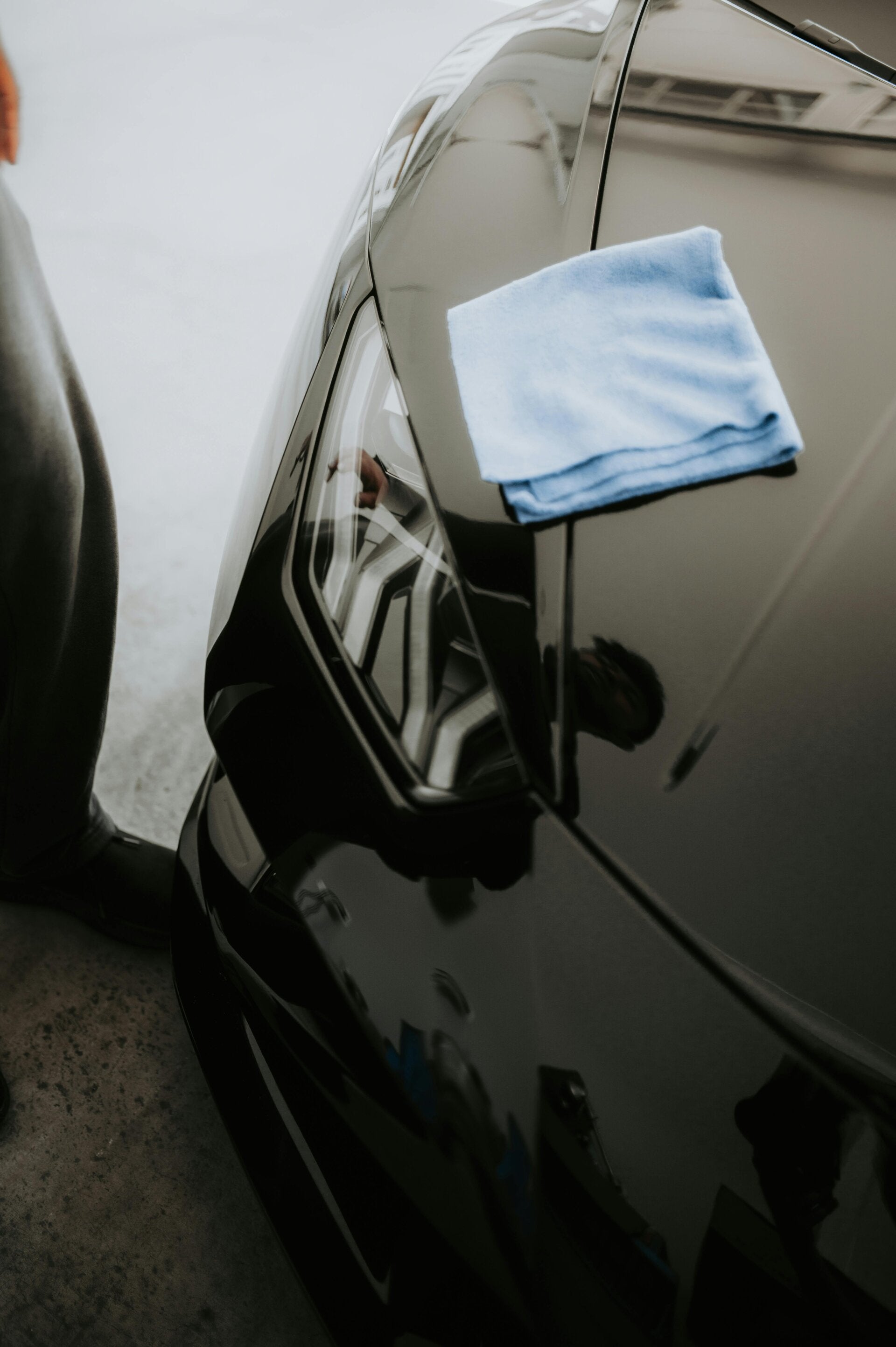 A freshly cleaned car being polished with a microfibre cloth